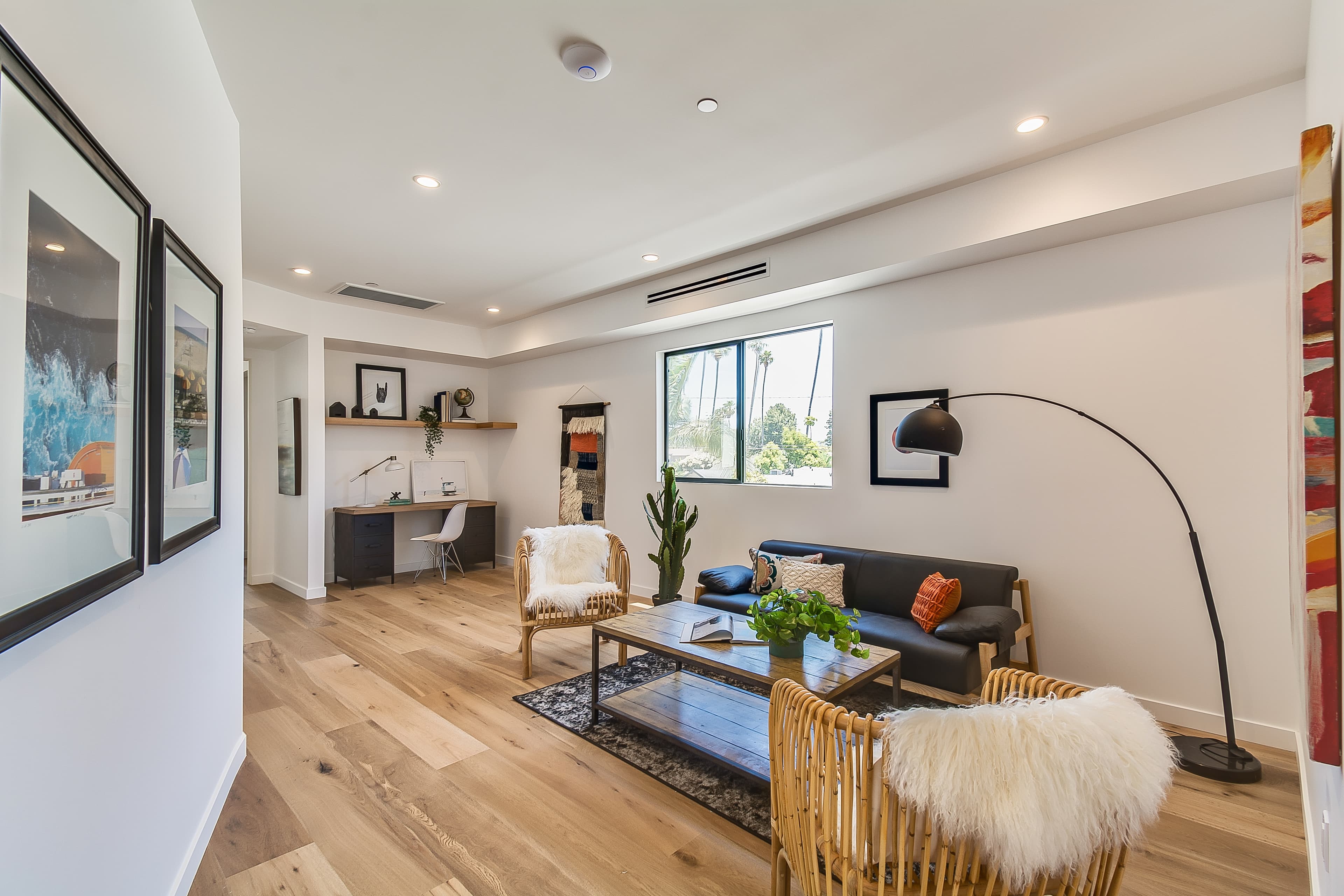 A modern, two-story residential home with a contemporary architectural design featuring clean geometric lines and a gray stone exterior.